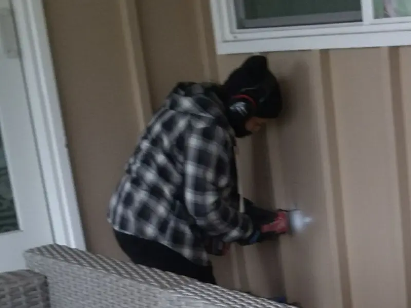 Professional electrician installing an exterior outlet in Westgate