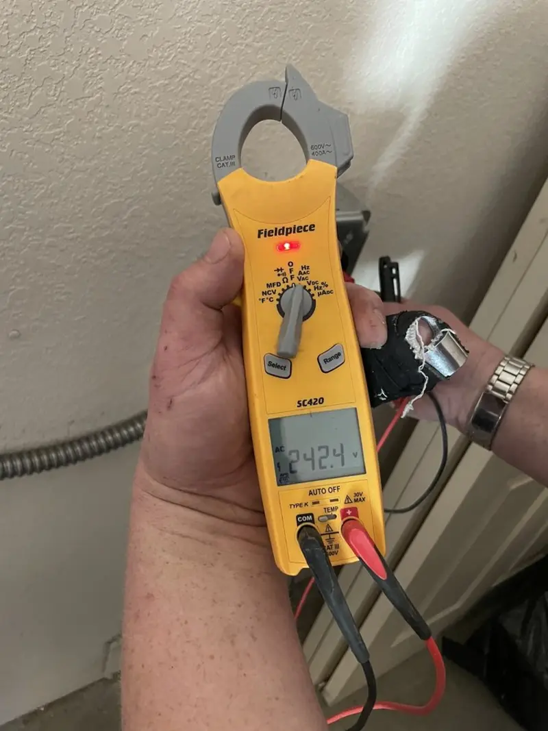 Voltage testing with clamp meter during Outlet Installation in Westgate